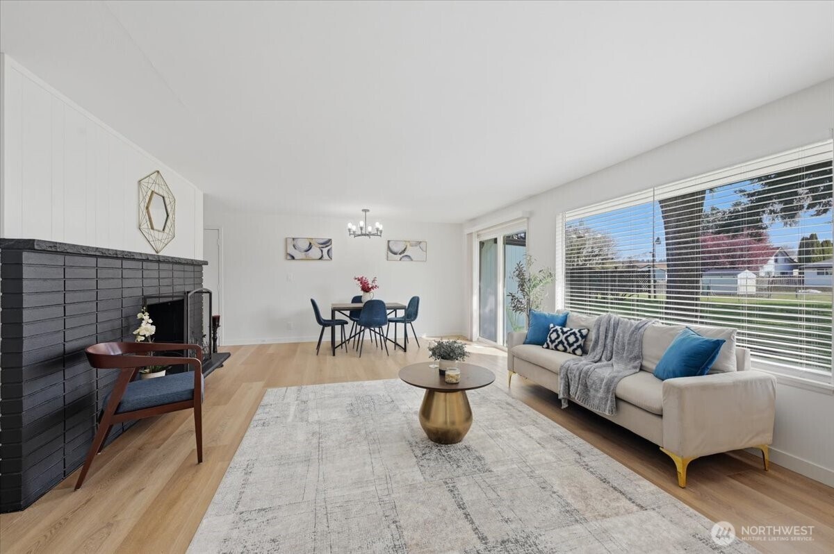 Large windows looking out onto the large level lot with alley access. Sliding door leads to the back patio.