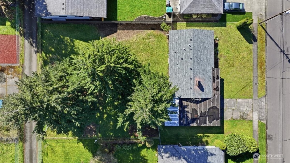 Large level backyard is fully fenced and offers alley access in back.