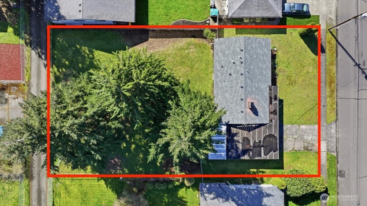 Large level backyard is fully fenced and offers alley access in back.