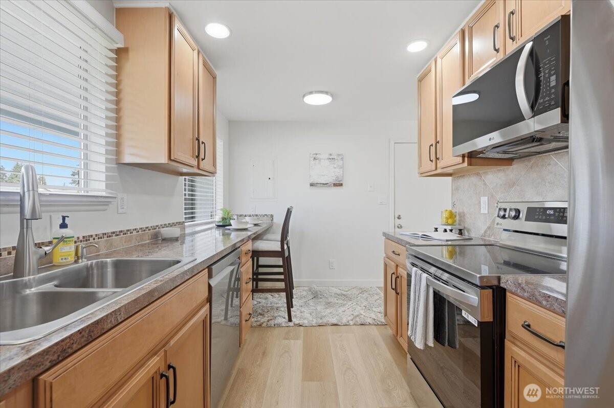 Remodeled kitchen with stainless appliances and eating nook, New interior paint throughout.