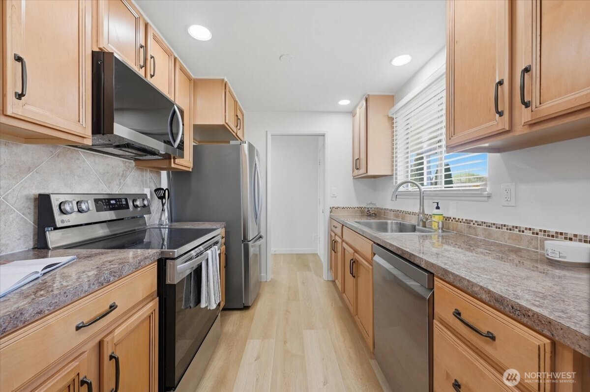 Remodeled kitchen with stainless appliances and eating nook. New interior paint throughout.