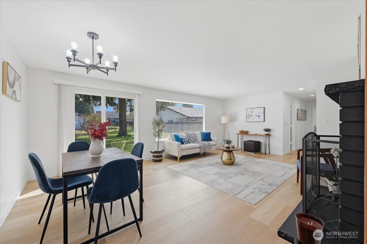 Living room with new luxury vinyl plank flooring throughout. Sliding door leads the backyard oasis. Light and bright!