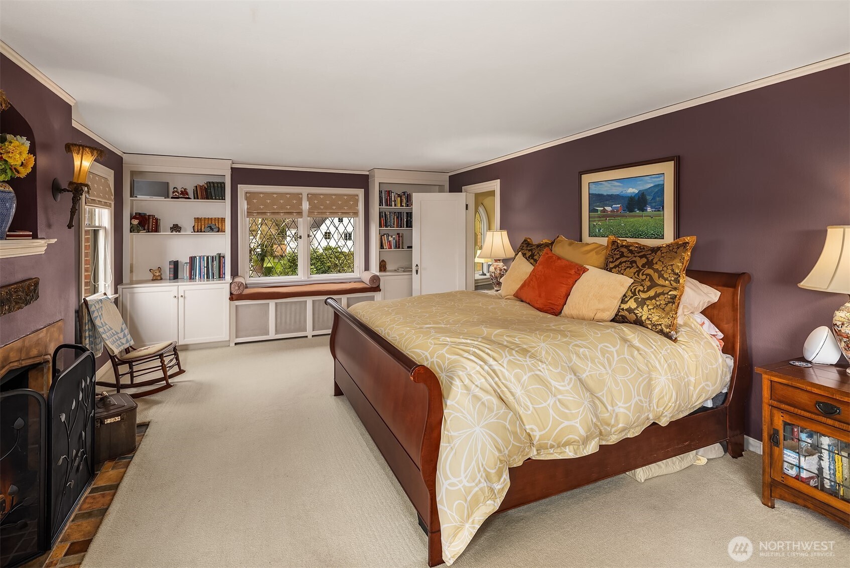 Primary suite with fireplace and views of  Portage Bay