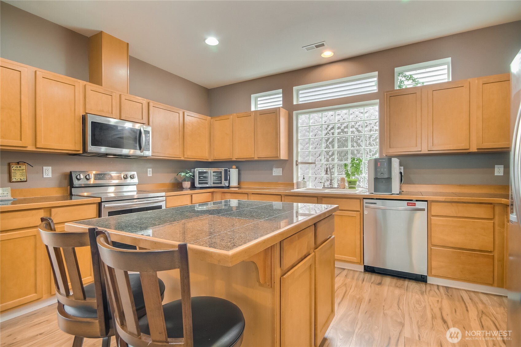Natural light filled kitchen has large window