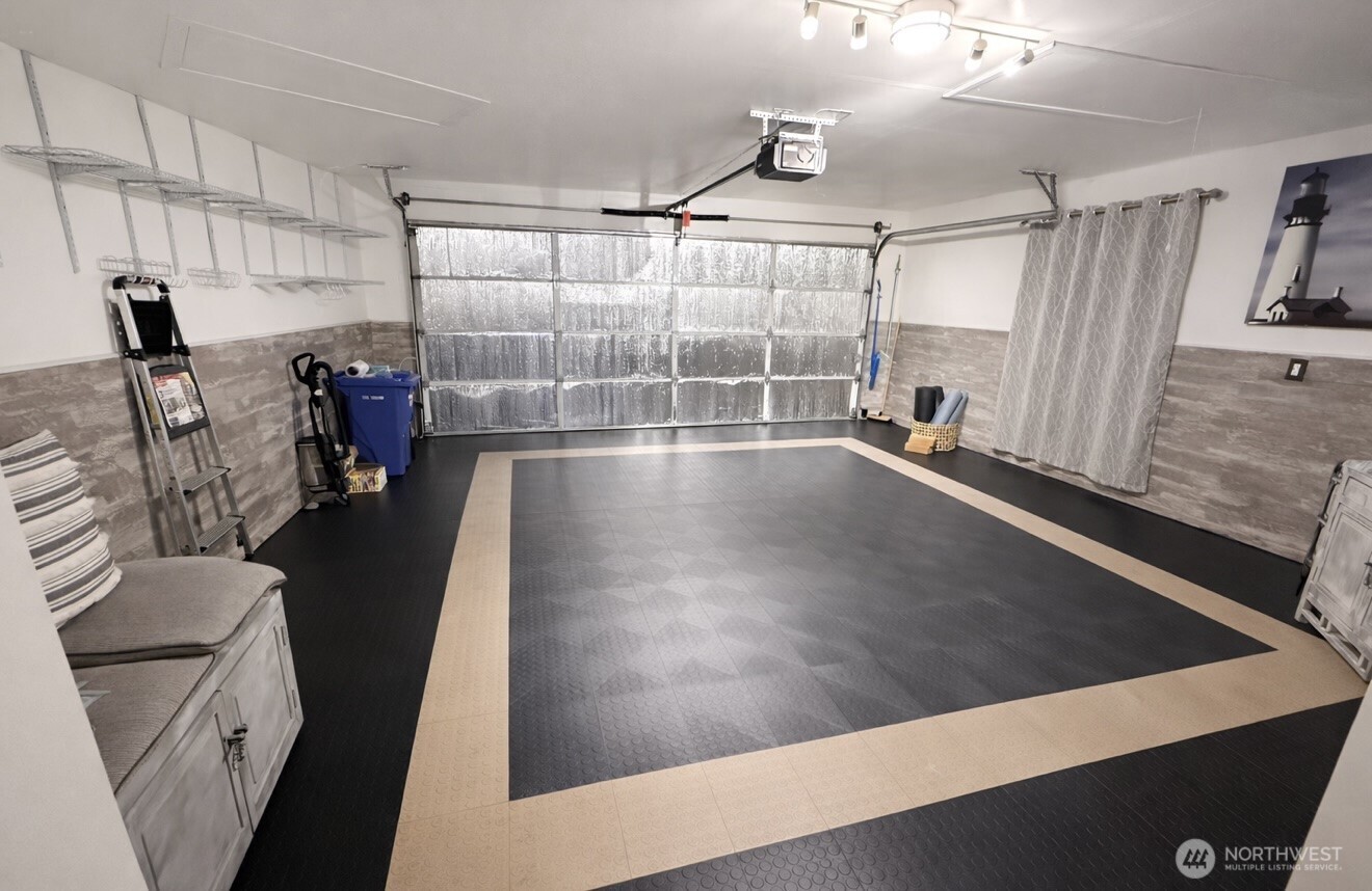 Insulated garage with easy clean floor padding