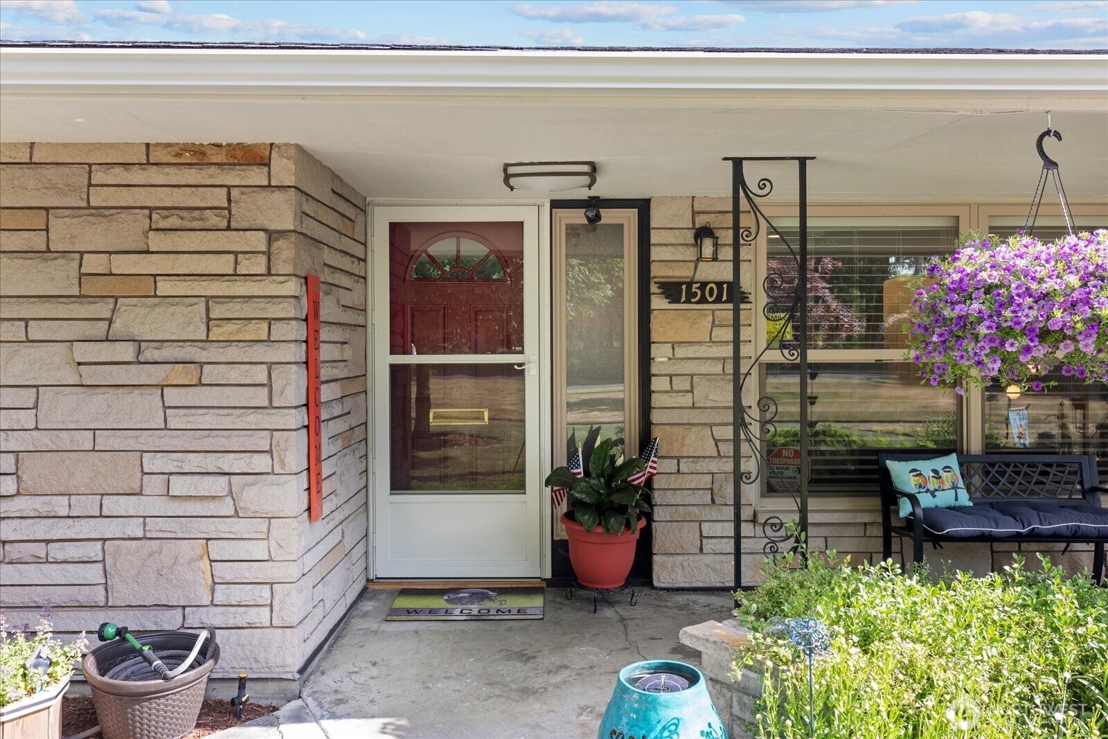 Welcoming covered front porch and inviting front entry.