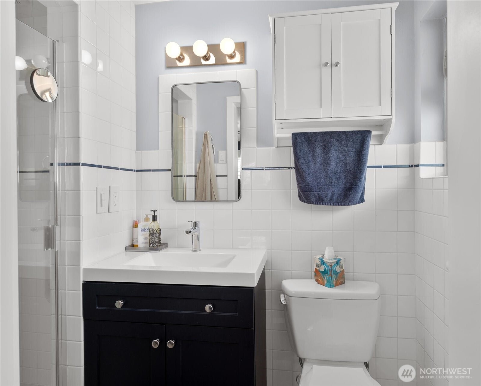 Updated bathroom featuring a modern vanity, classic tile surround, and clean finishes.