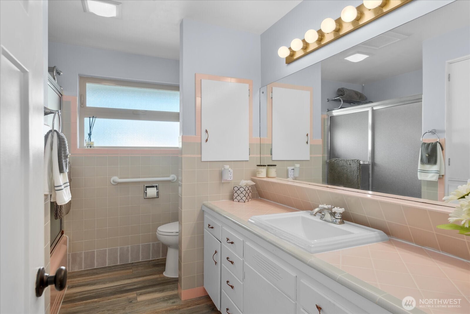 Generous bathroom with extended vanity, classic tile detail, and abundant counter space.