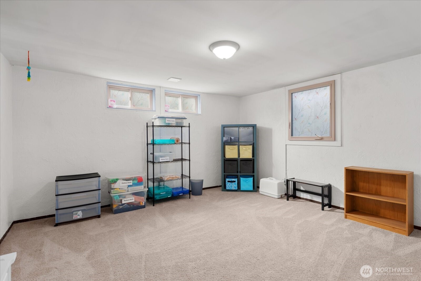 Oversized lower-level bedroom offering flexible space for guests, hobbies, or work area.