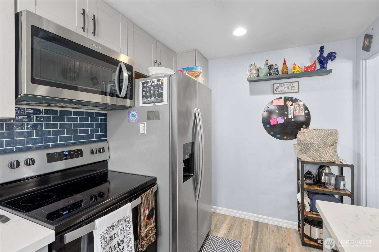 Stainless appliances and abundant cabinetry create a functional and well-designed kitchen workspace.