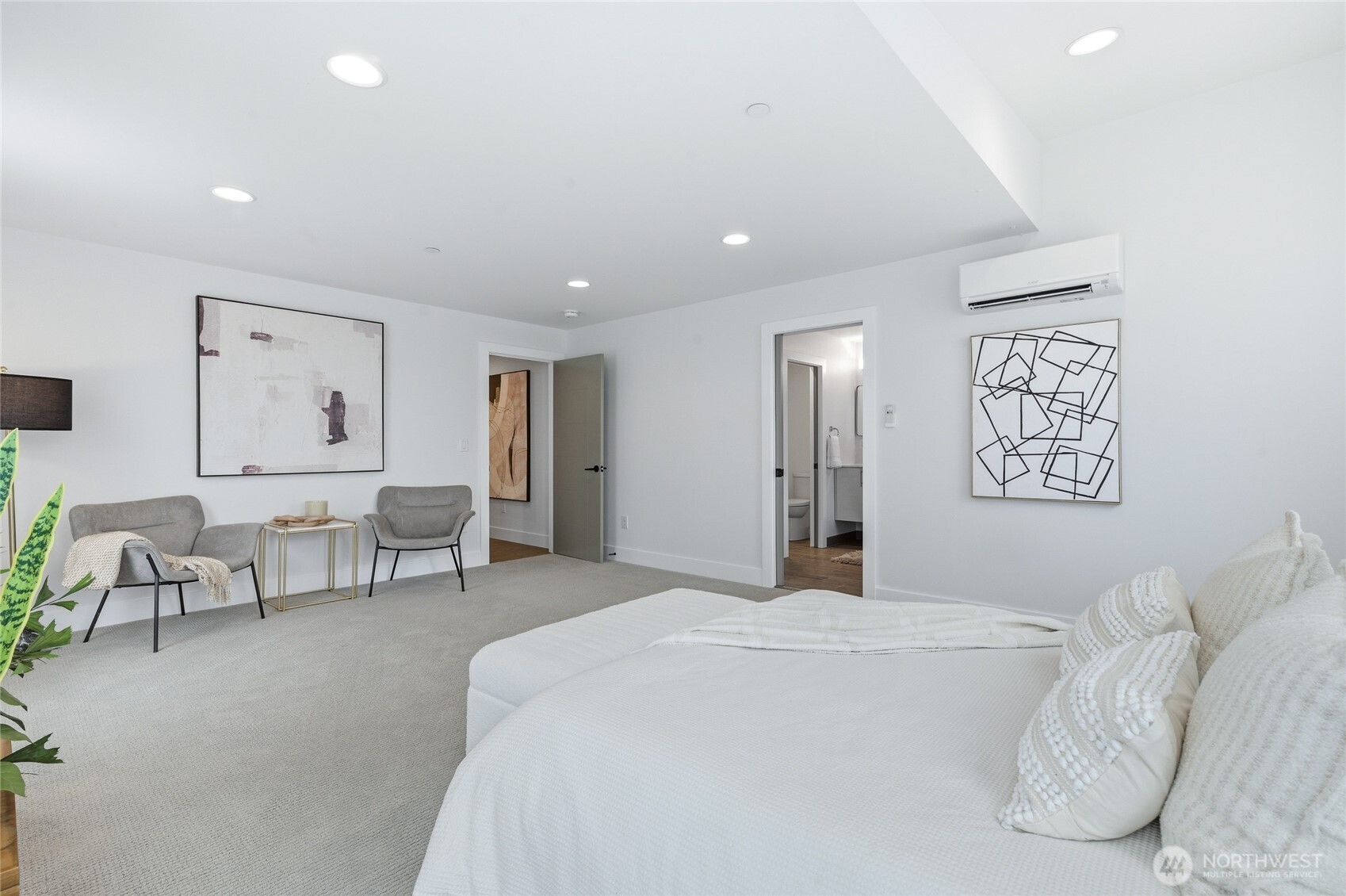 Sumptuous primary suite with walls of windows. Additional sitting area