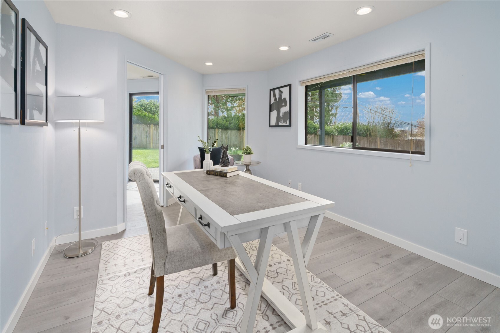 Lower level laundry room with sink and large doggie door to fenced yard