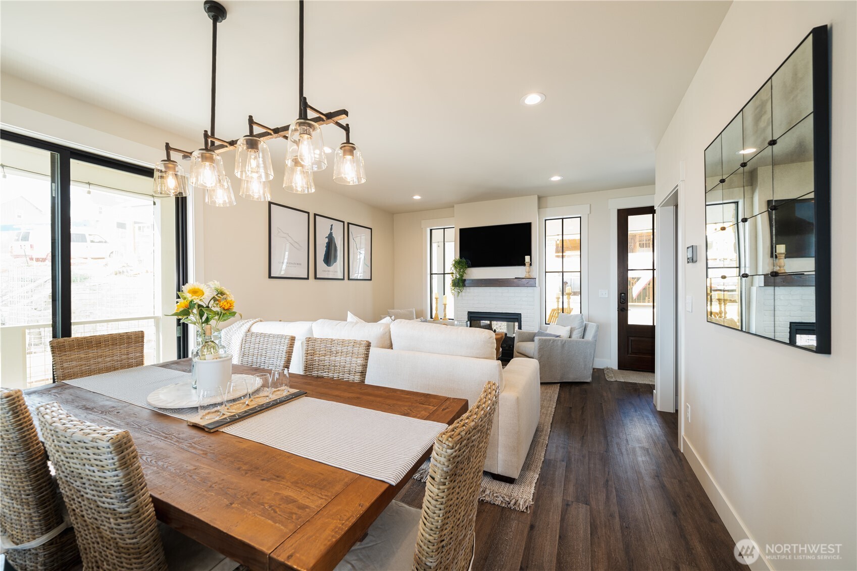 View of dining room and living room with double sided fireplace.