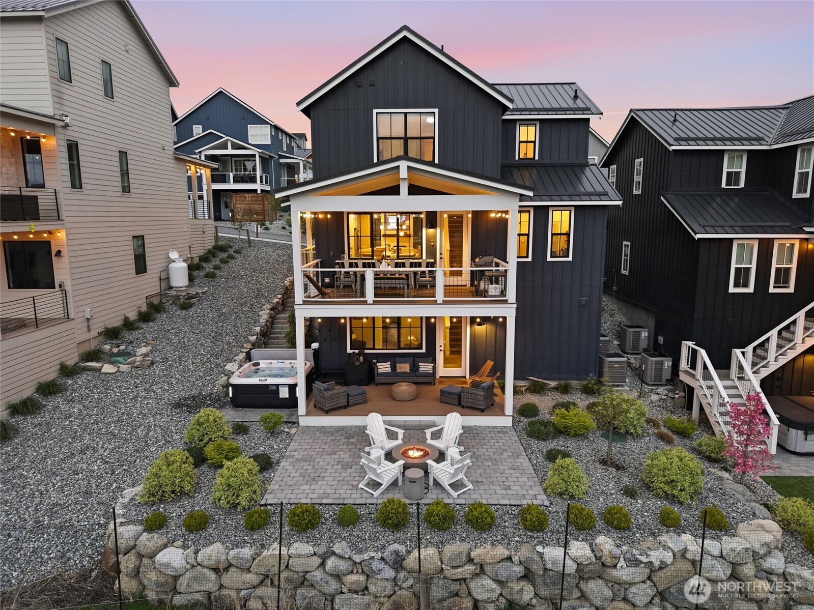 Exterior twilight view of home and outdoor living space.