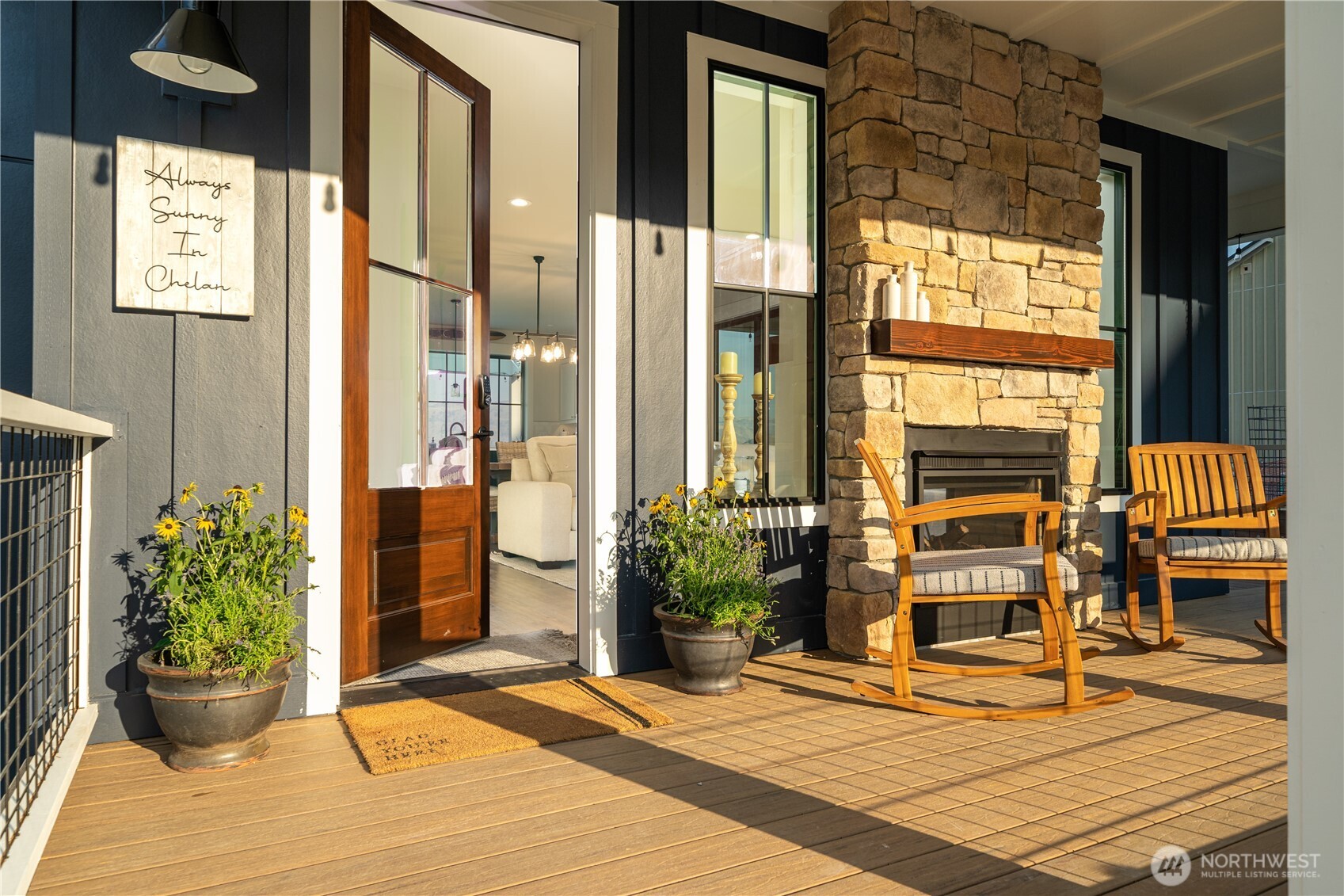 Front door entry with engineered wraparound porch and double sided fireplace.