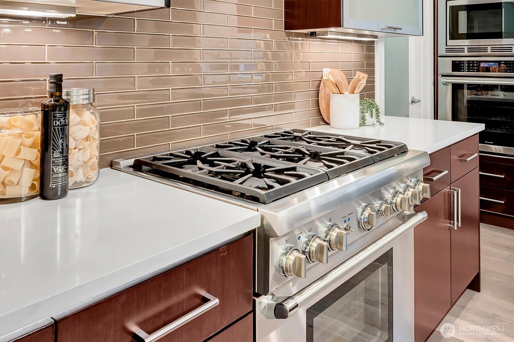 Double ovens, and a 6-burner gas cooktop.