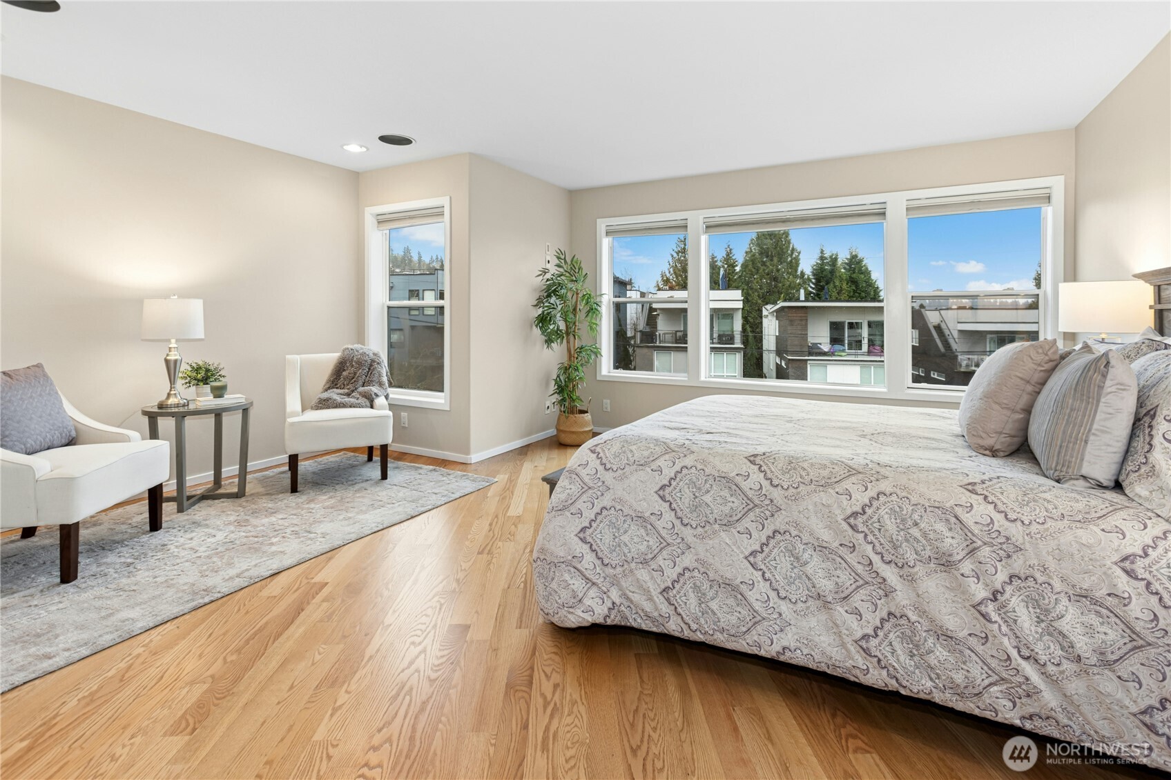 Upstairs you will find the spacious primary suite with beautiful hardwood flooring! Look out these windows to the right and you'll see Lake Washington.