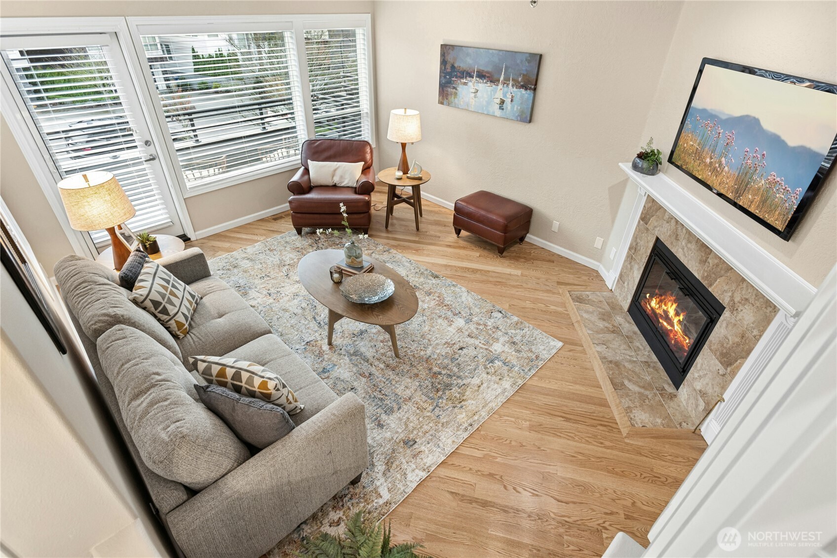 Here is another look at the living room with gleaming hardwood floors and a newer gas fireplace insert.