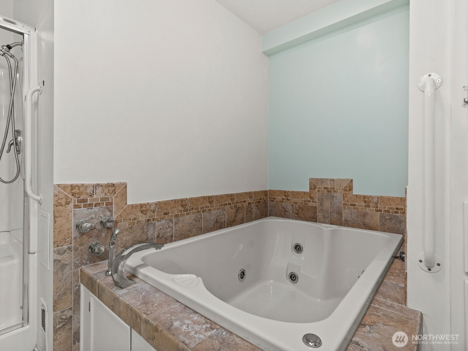 The ensuite bathroom has a jetted soaking tub, perfect for relaxing after a long day.