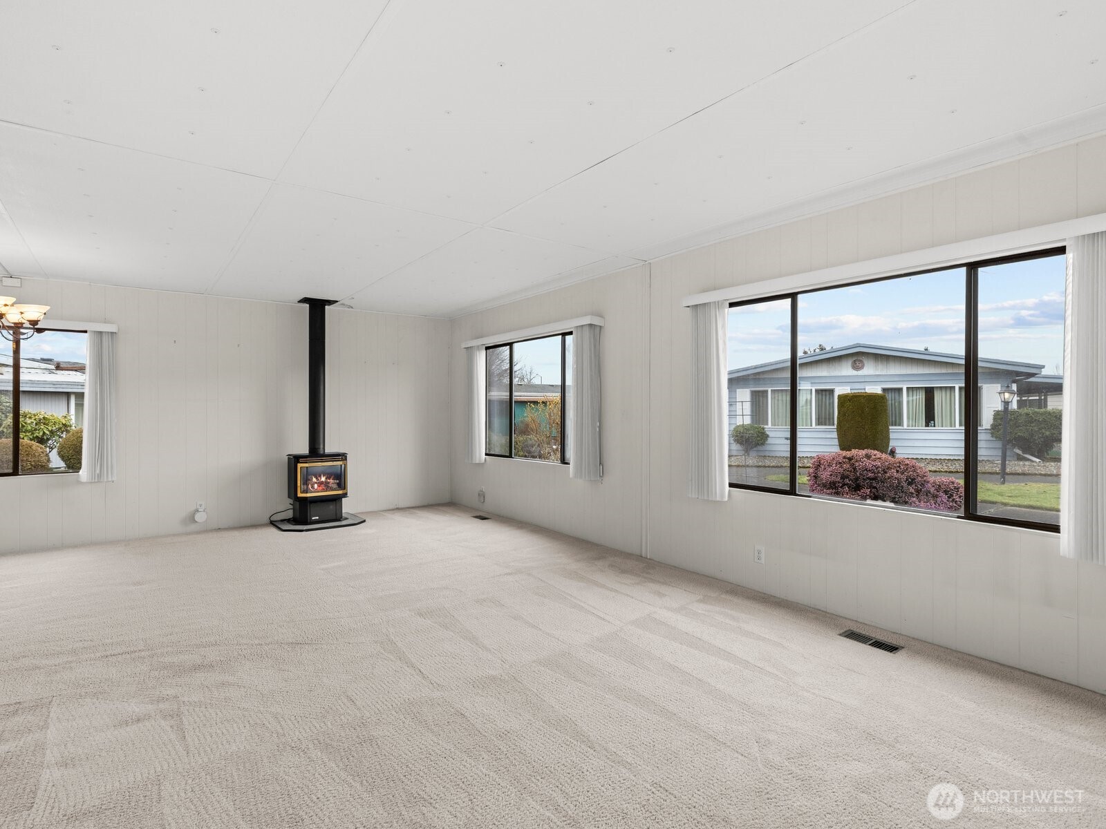 As you enter, natural light fills the home through the large windows.