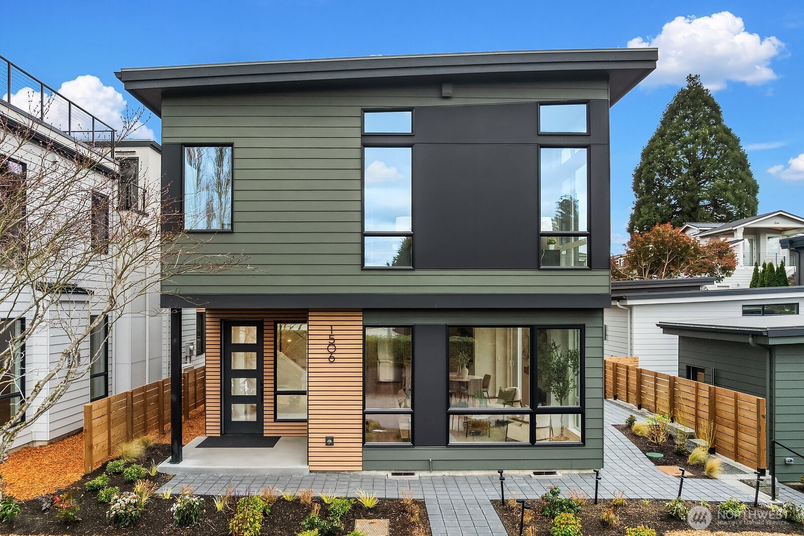 Paver entry wraps around to side of home. Detached garage shown at right.