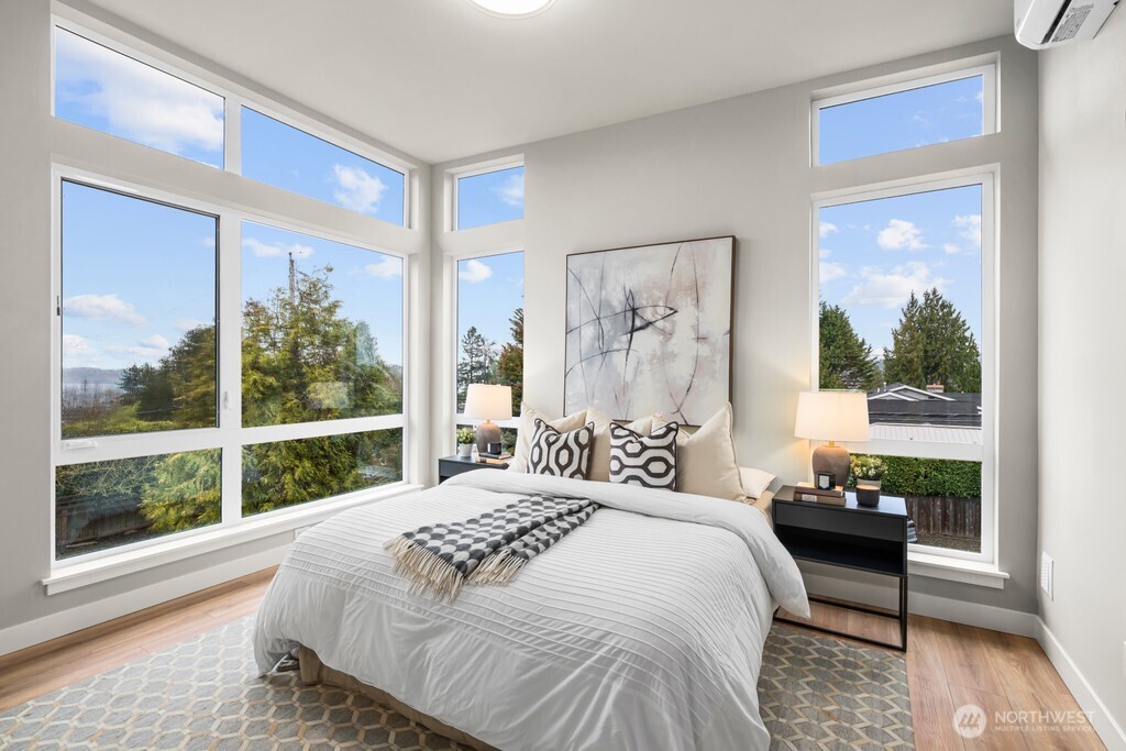 Main floor powder bathroom with privacy glass at window and floating vanity.
