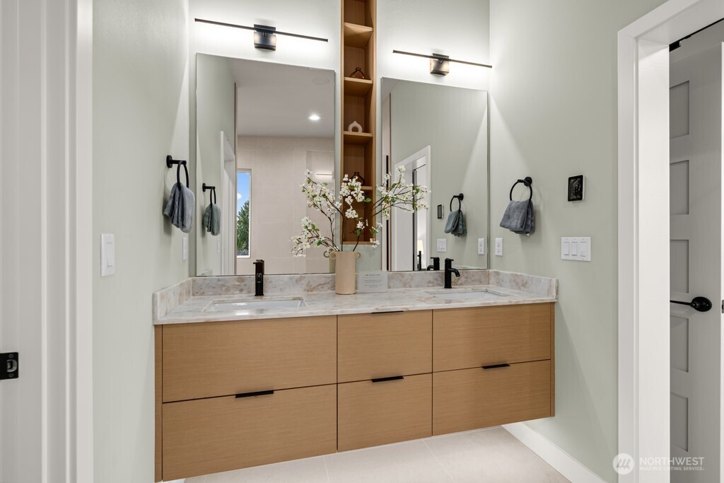 In the primary bath… statement matte black soaking tub from Signature Hardware anchors the massive shower. Heated floors for cozy toes.