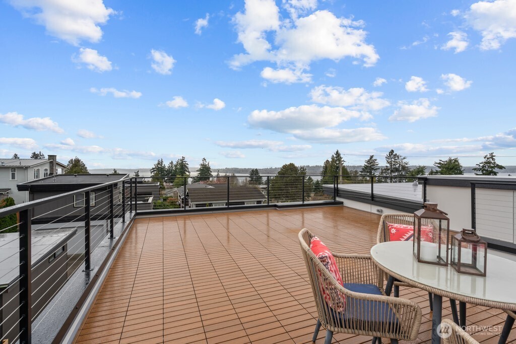 Glamorous laundry room with miles of countertop, a long stretch of cabinets, open shelving, and playful tiled floors. Utility sink, too. Smart LG washer and dryer included.