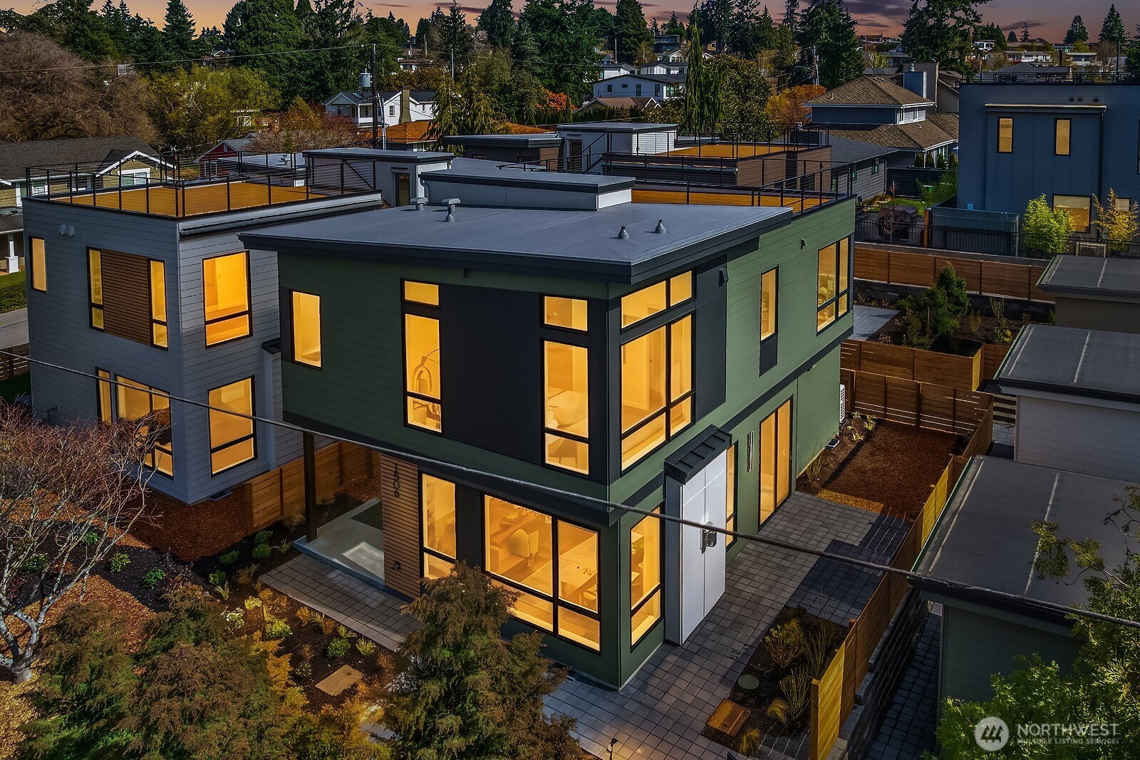 An overhead look at the precise architecture with tidy, fenced landscape and patio.