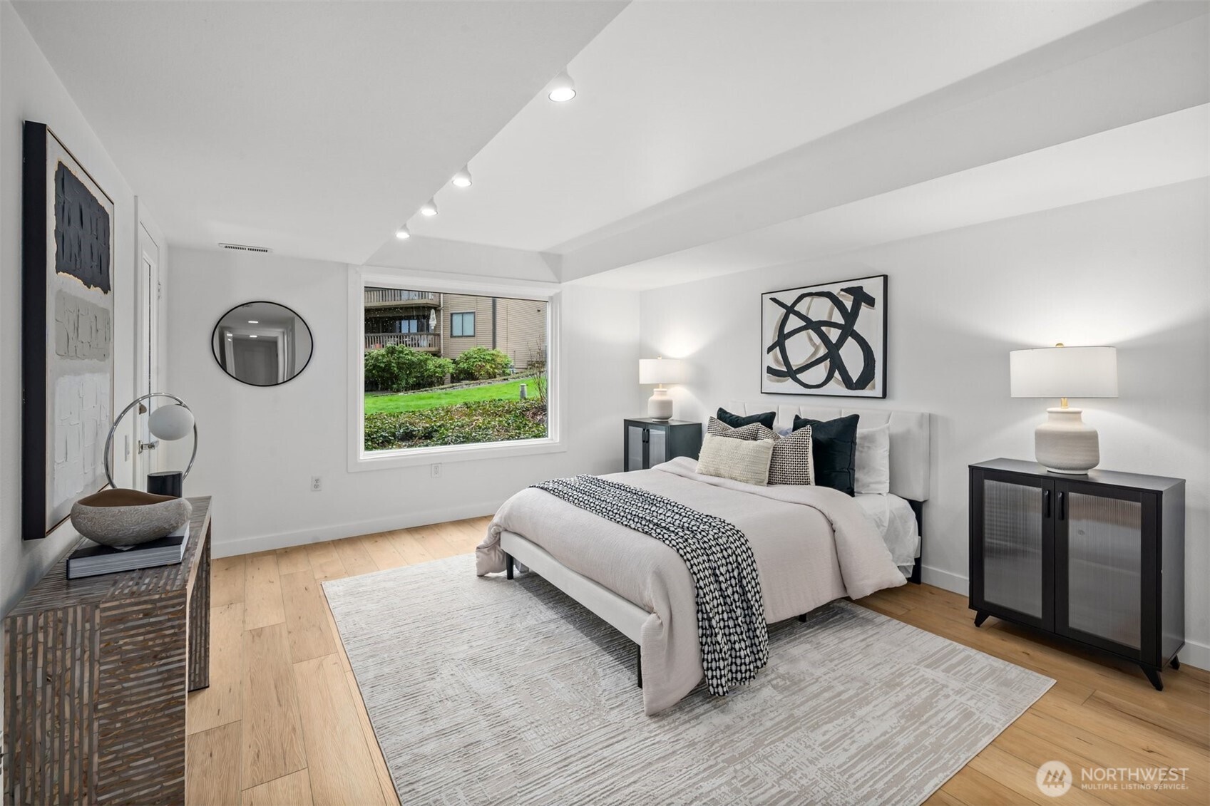 A spacious and luxurious primary suite, offering seamless patio access, stunning views, a generous walk-in closet, and a beautifully appointed attached bath.