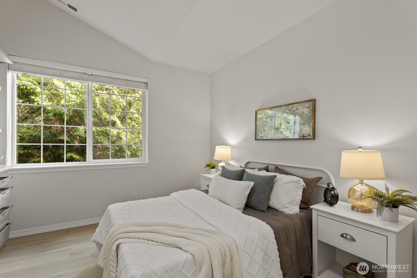 The second bedroom is nice and spacious as well, with a serene treed view right outside.