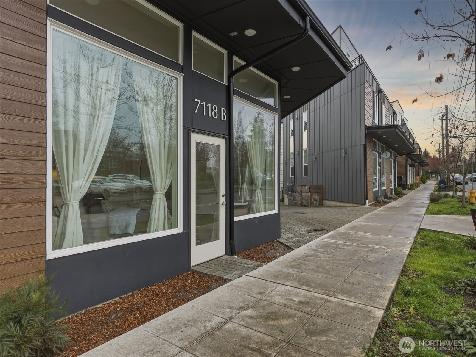 The live/work entrance on Beacon Ave offers valuable street-facing exposure for a small business