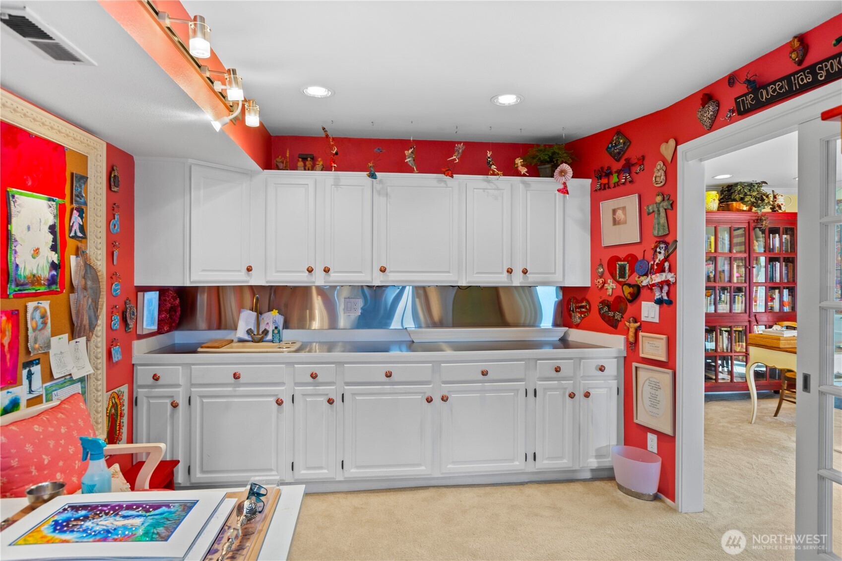 Laundry room with sink and plenty of cabinets for storage.