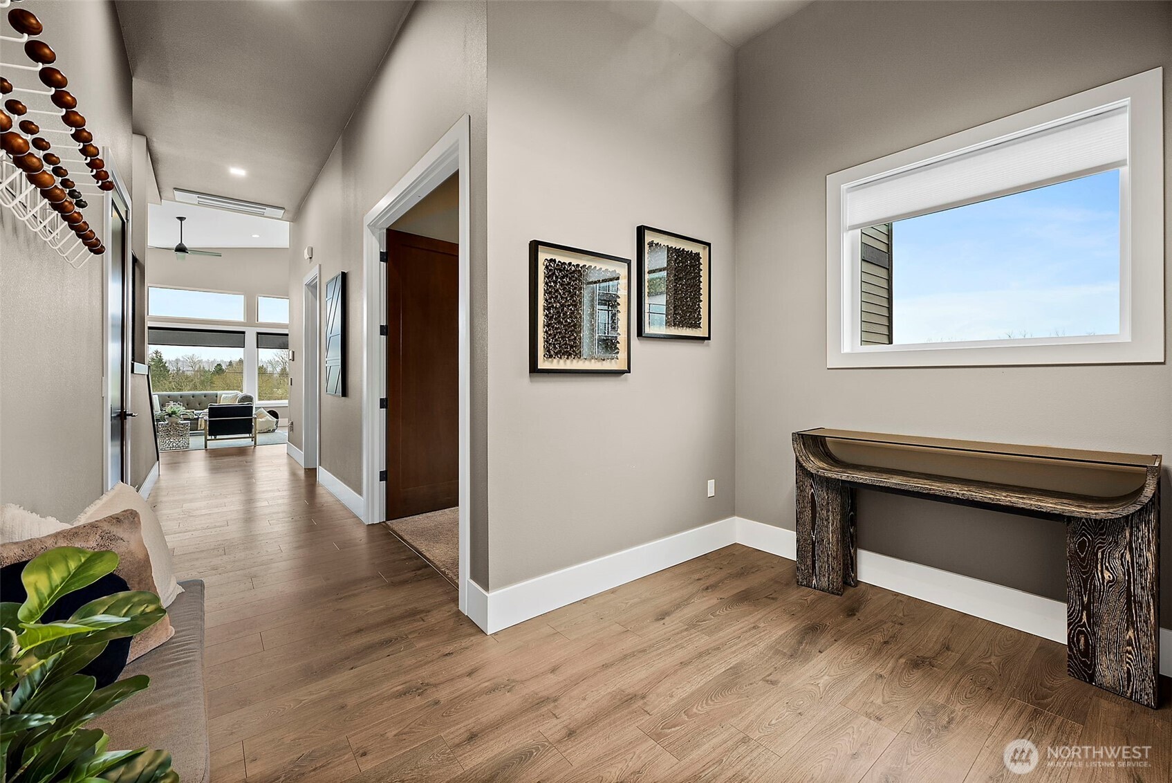 Welcoming entry foyer in this River Rock home in Auburn featuring wide plank flooring, modern finishes, and a bright hallway that opens toward the main living spaces. The clean design creates an inviting first impression as you enter the home.