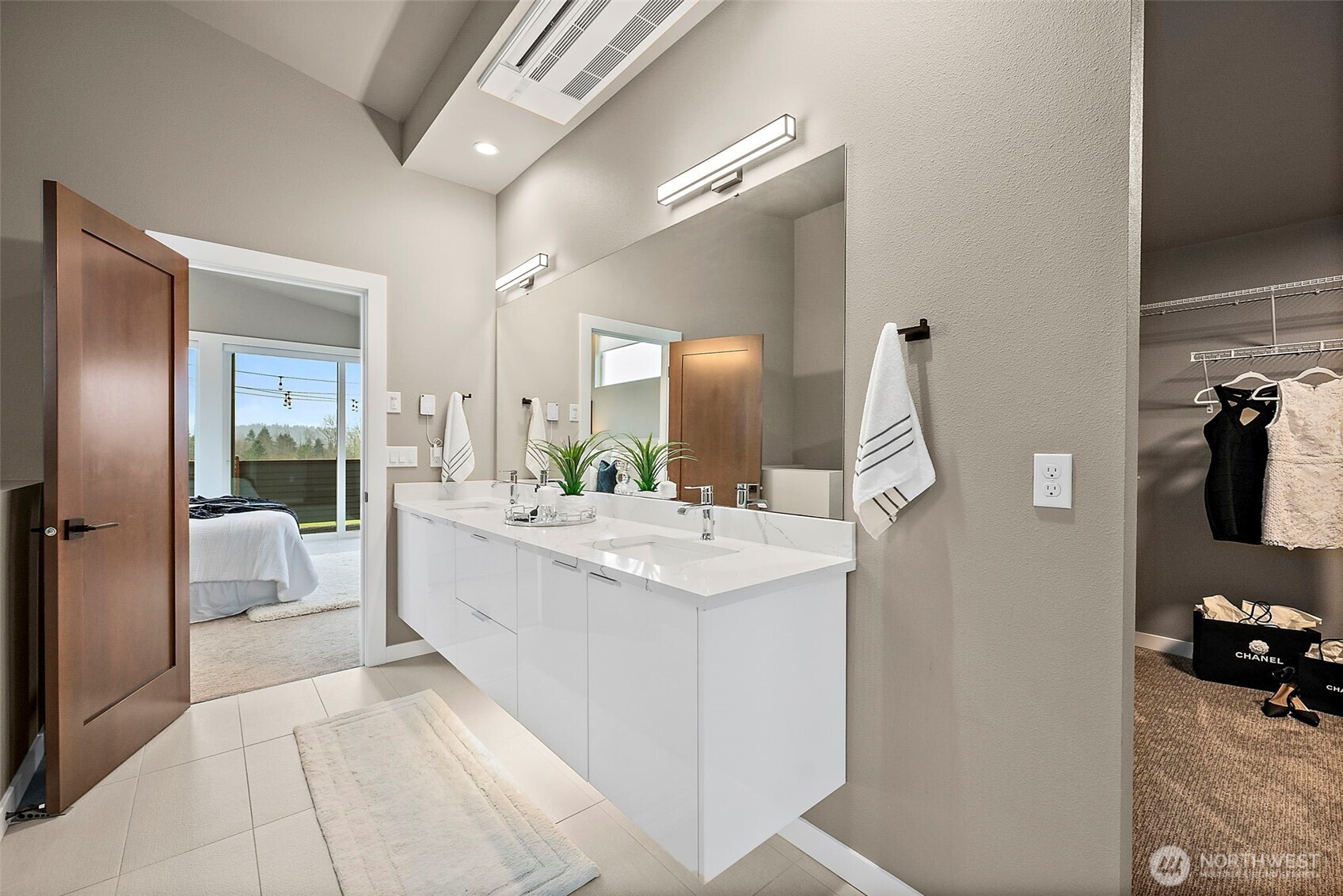 Floating vanity in the primary bathroom with under mount lighting