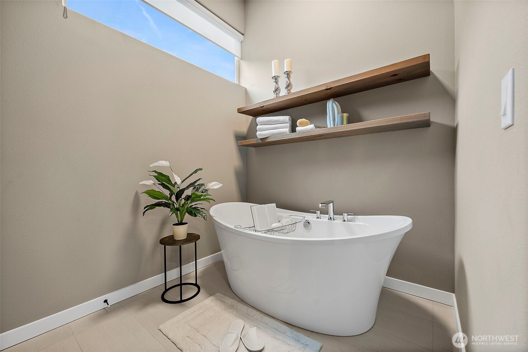 Primary bathroom in this River Rock home in Auburn features a spa style layout with dual vanity, modern finishes, walk in shower, and a freestanding soaking tub. The bright and spacious design creates a relaxing retreat with clean lines and contemporary comfort.