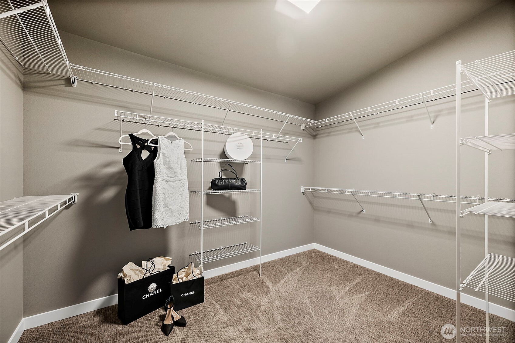 Spacious walk in closet with built in shelving and ample storage for clothing, shoes, and accessories. The organized layout adds convenience and functionality to this Auburn River Rock home.