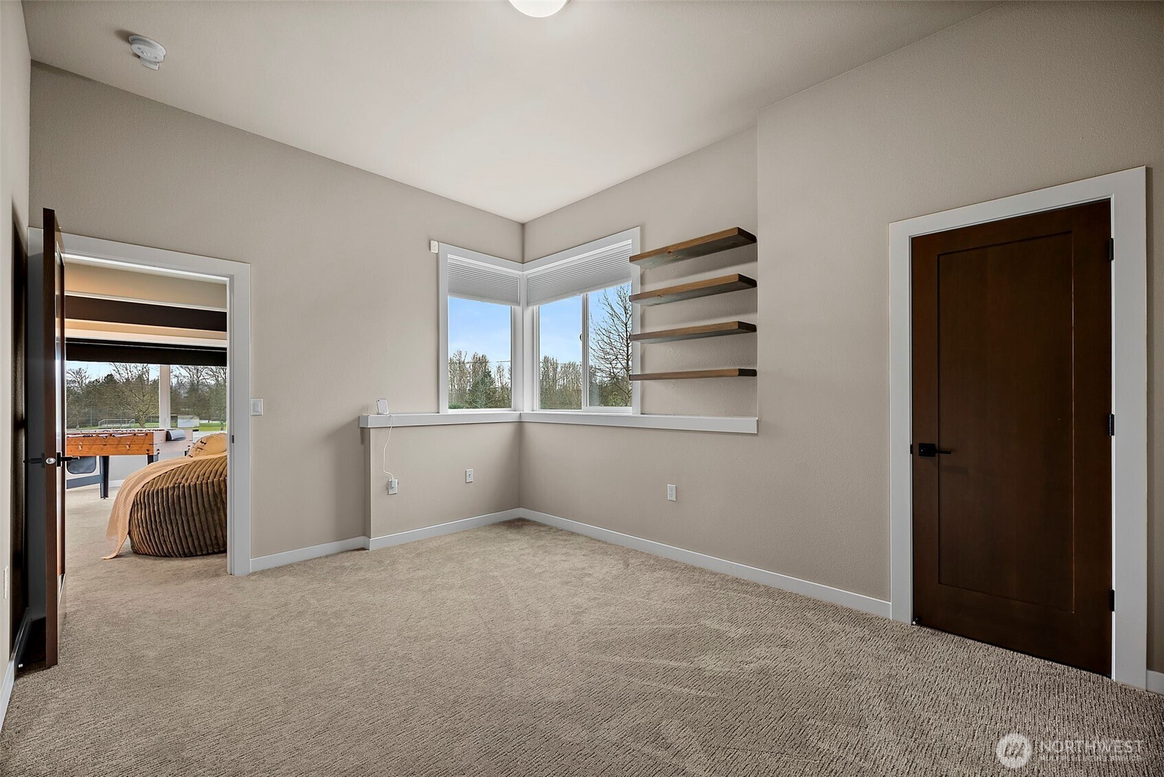 Additional bedroom in this River Rock home in Auburn features a bright layout with large windows, soft carpeting, and flexible space for guests, family, or a home office. The comfortable design provides privacy and easy access to nearby bathrooms and living areas.