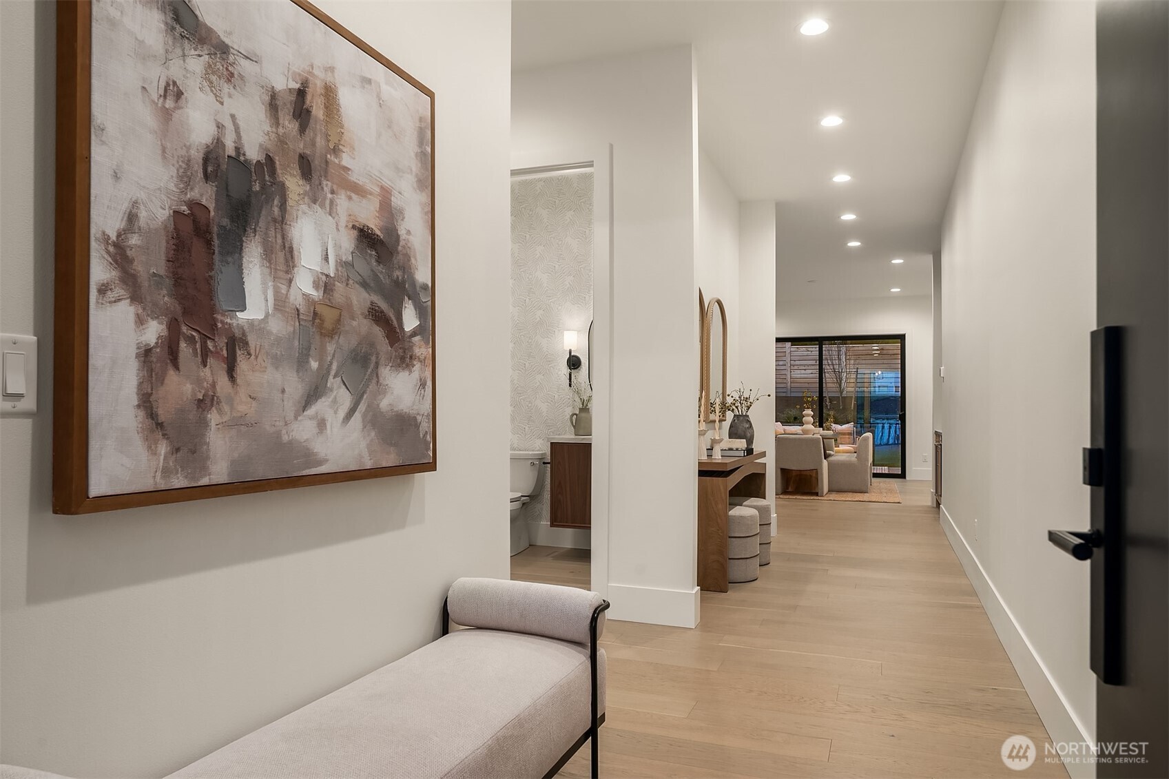 A striking Tru Stile solid slab front door opens to a grand, light-filled entry designed to create an immediate sense of arrival and sophistication.