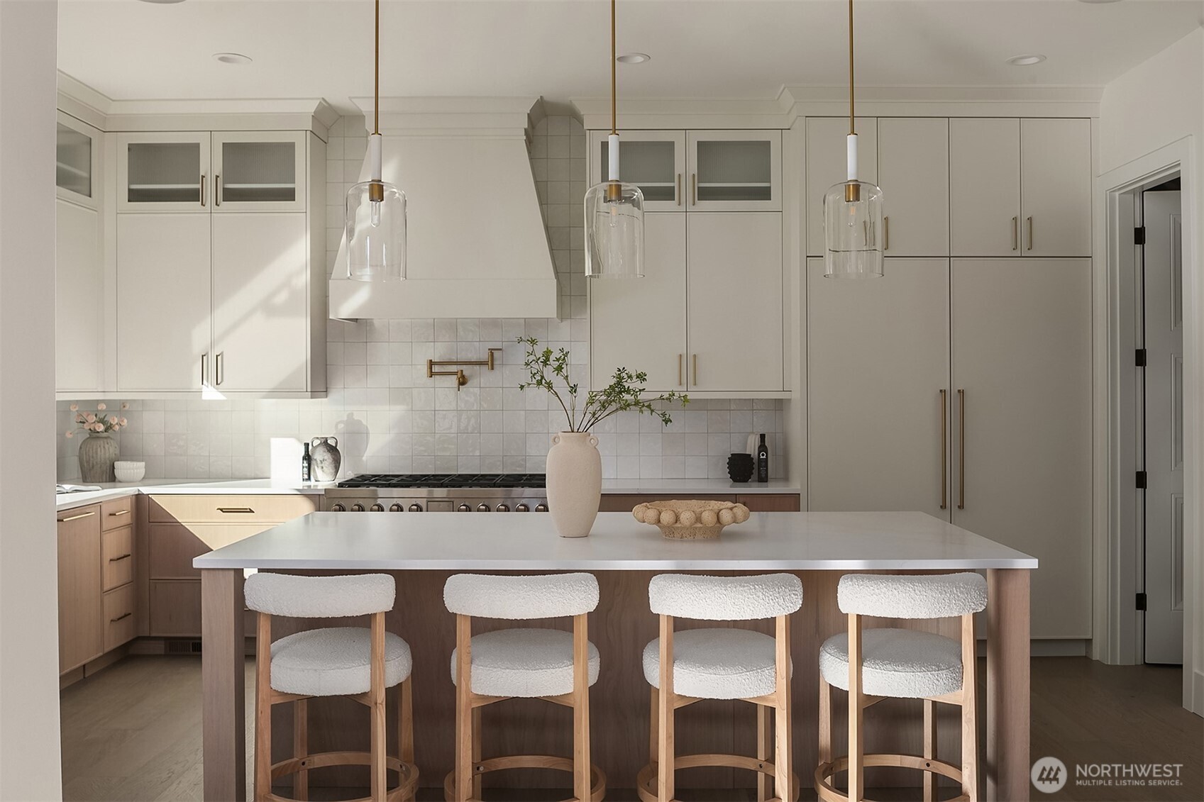 The chef’s kitchen showcases premium Wolf and Sub-Zero appliances, a custom-paneled refrigerator, freezer, and dishwasher, a 48-inch bespoke hood vent, and a convenient pot filler — designed for both elevated entertaining and everyday living.