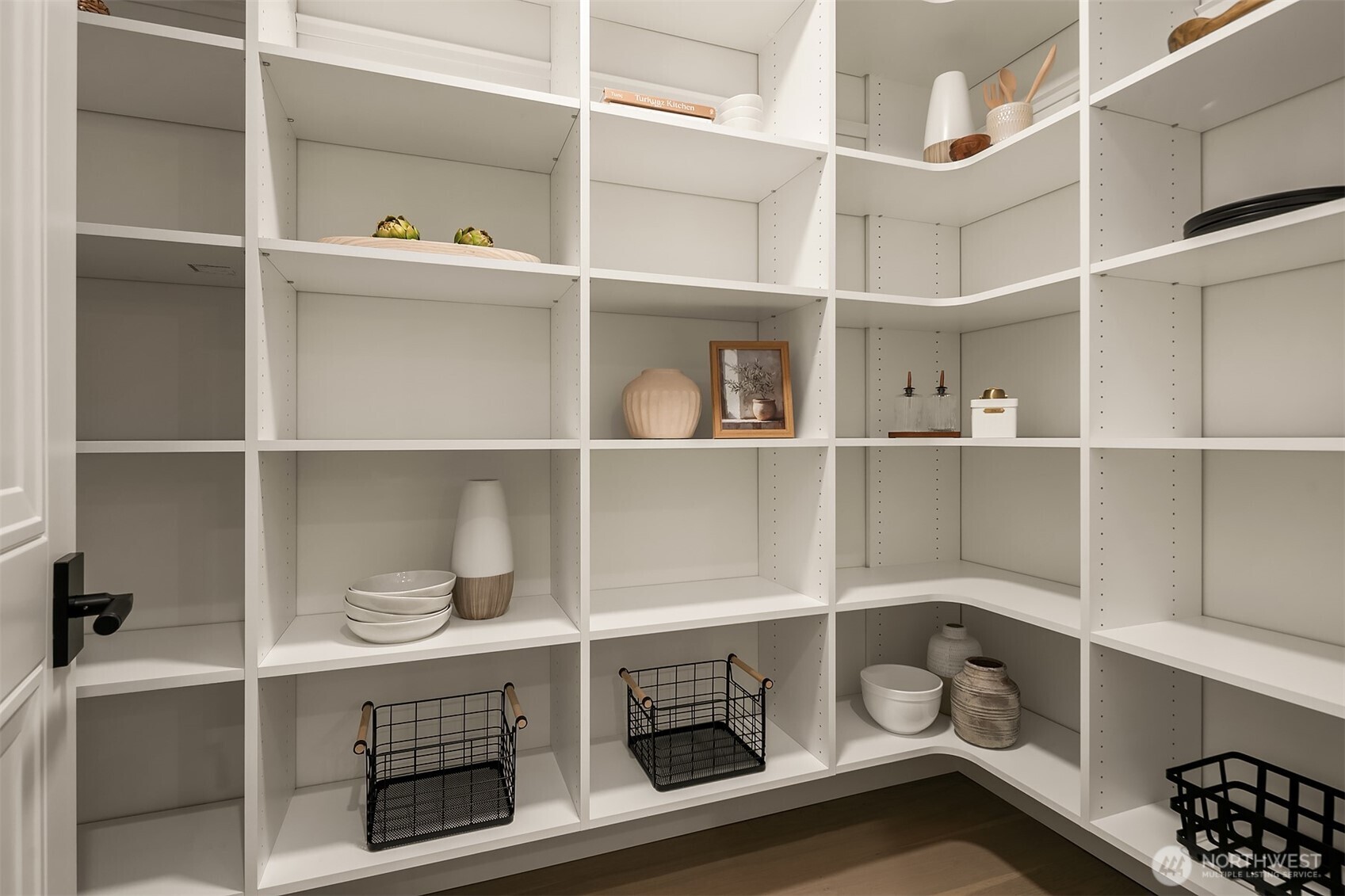 An extra-spacious walk-in pantry designed for ultimate organization, featuring motion-sensor lighting and abundant shelving to elegantly store everything from daily essentials to specialty kitchen items — where functionality meets thoughtful design.