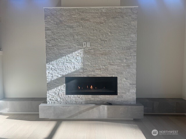 linear gas fireplace with stone facade and raised tile hearth
