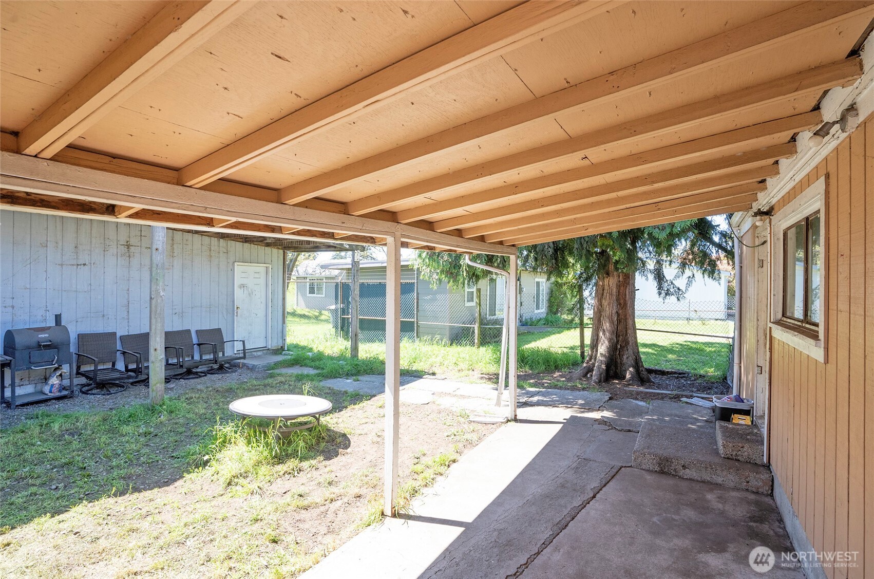 Covered back patio with access to the detached 1,520 SF shop.