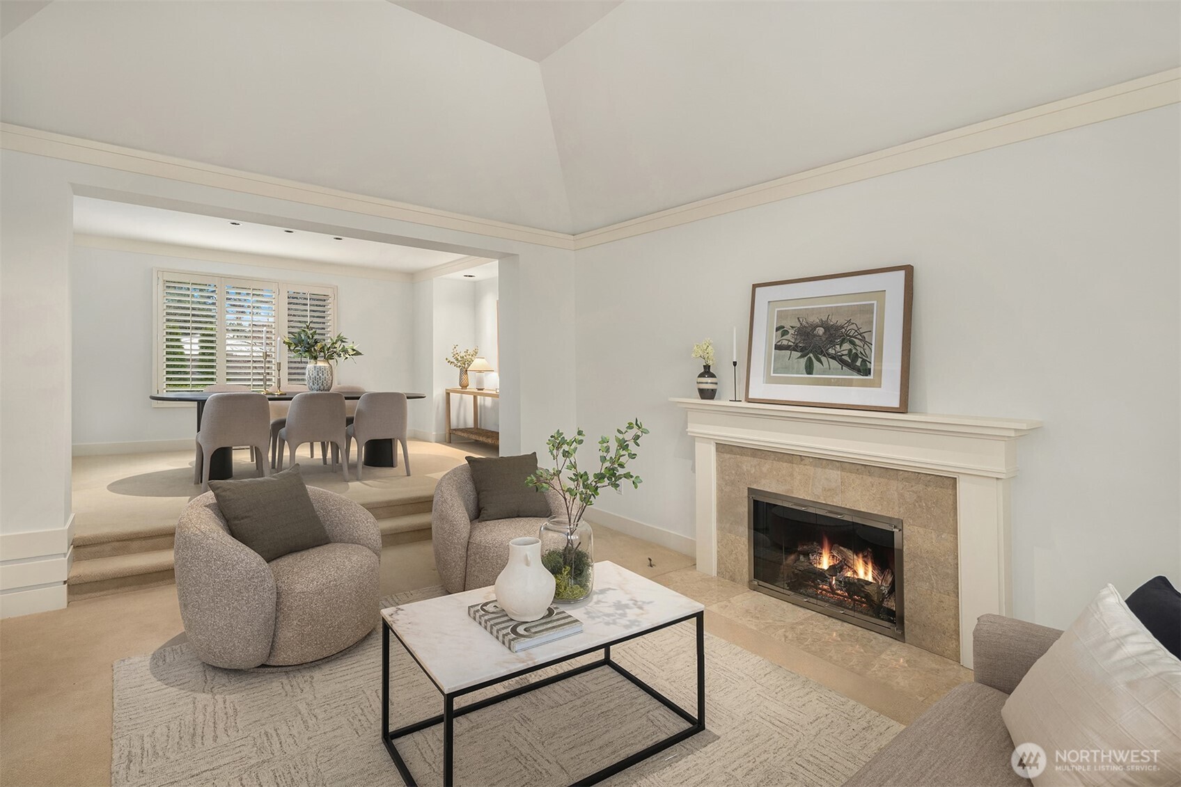 Inside, a bright and inviting floor plan features vaulted ceilings, expansive windows, and two cozy fireplaces that create warm, elegant living spaces.