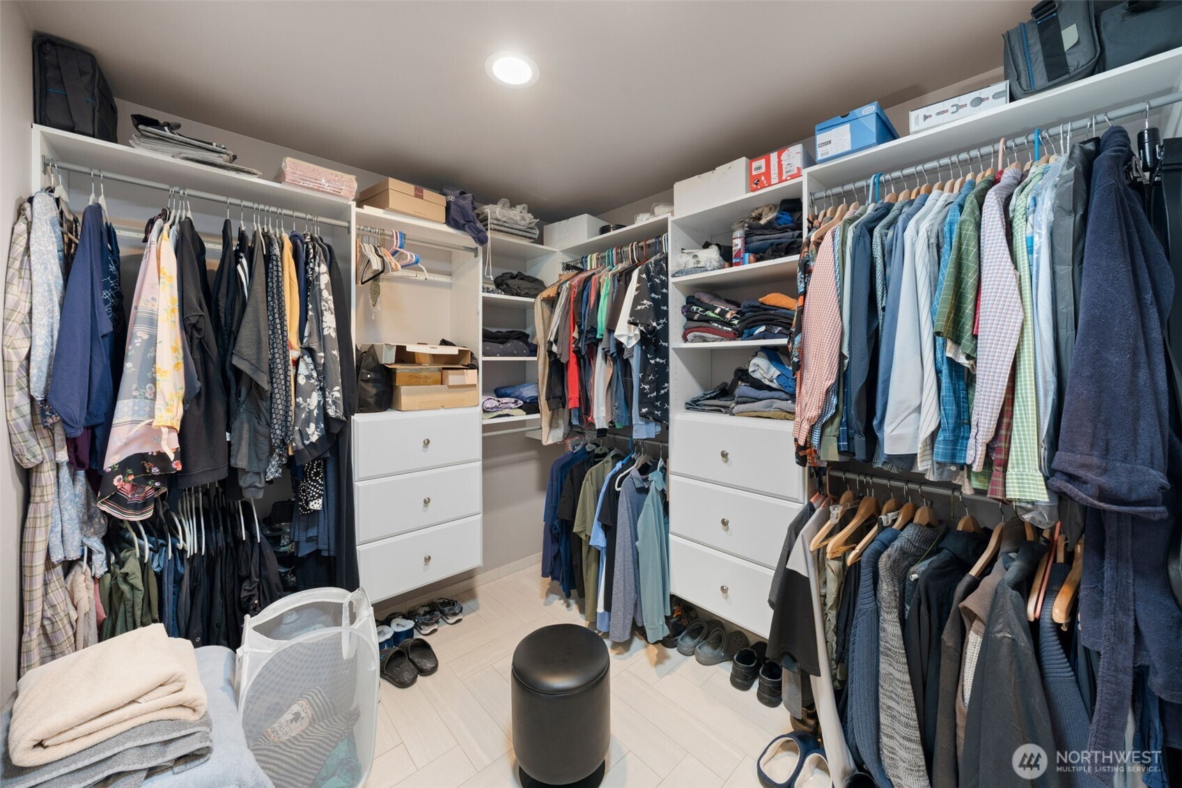 Large walk-in closet with extensive hanging space and built-in organization.