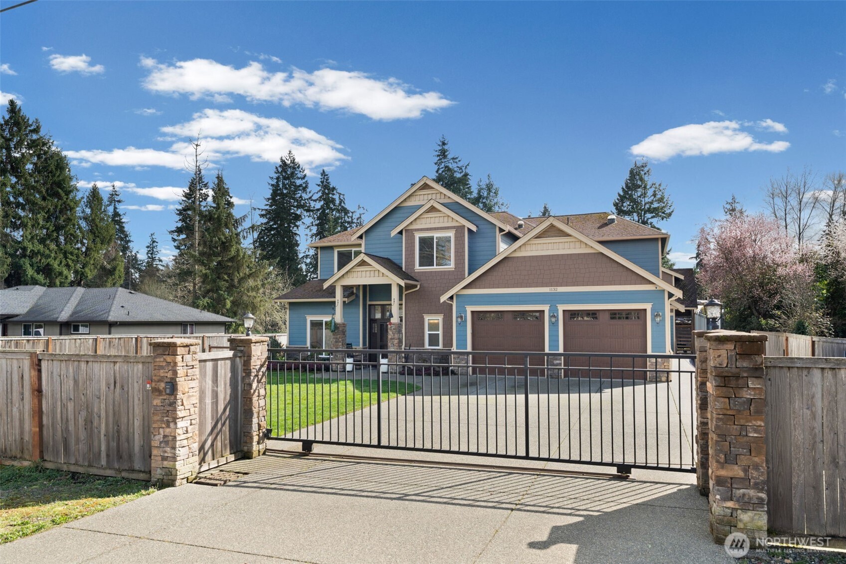 Welcoming front exterior with attractive curb appeal and a spacious driveway and automatic opening gate.