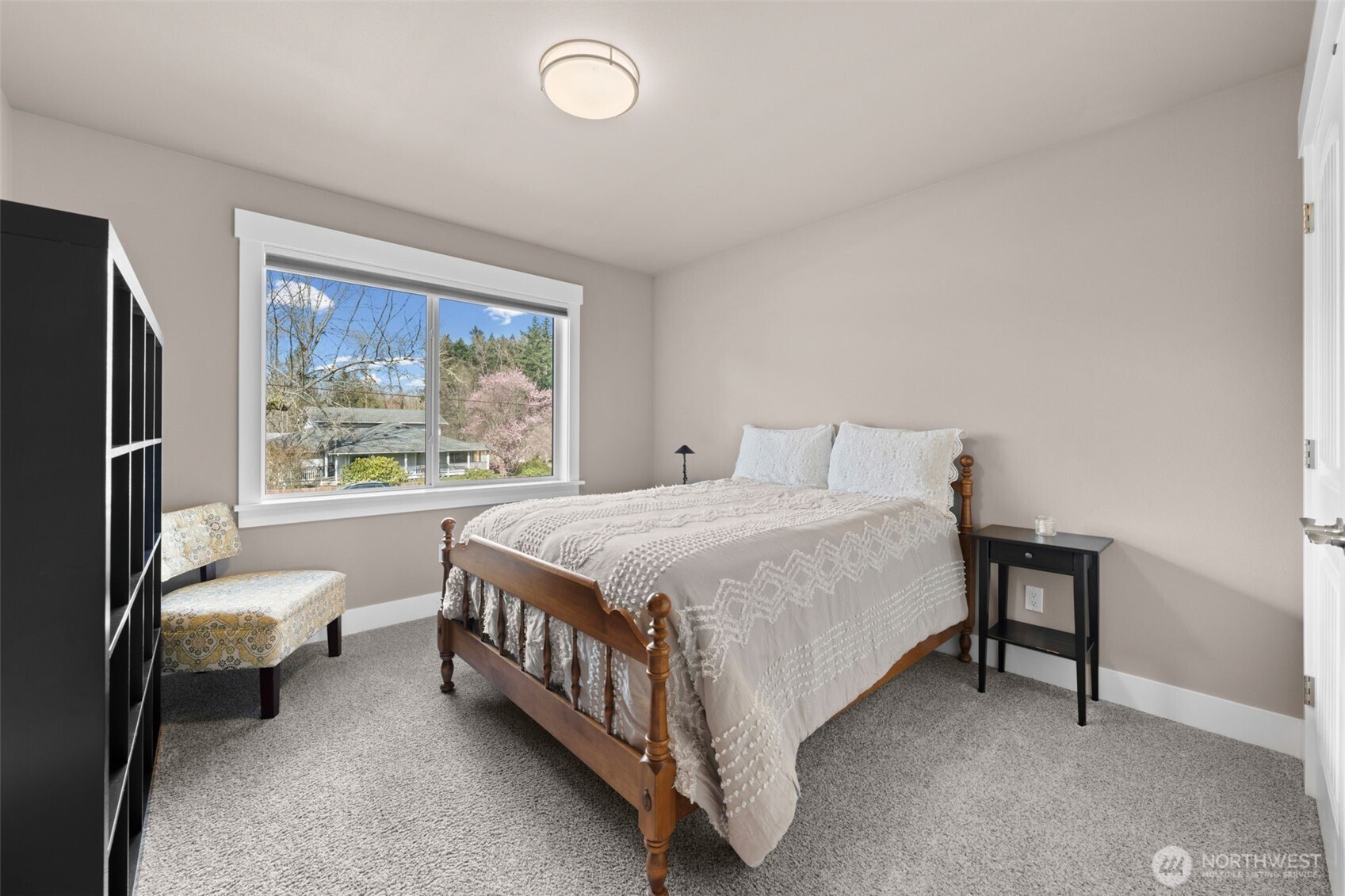 Spacious bedroom with large window and soft natural light. Connected to jack and Jill bathroom.