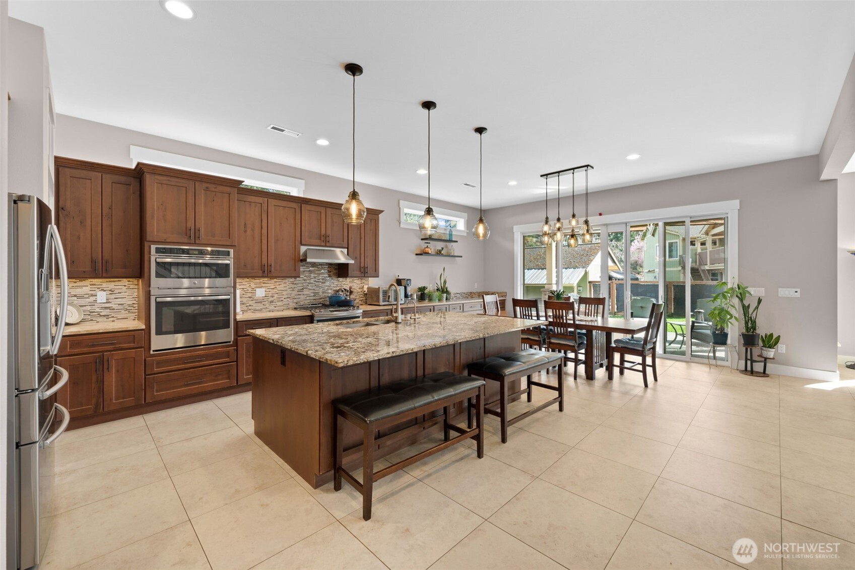 Beautiful kitchen with eating space and island with sink.