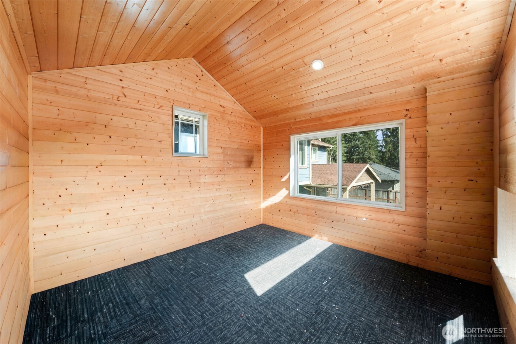 Detached outdoor structure with covered lower-level space and unique architectural character.