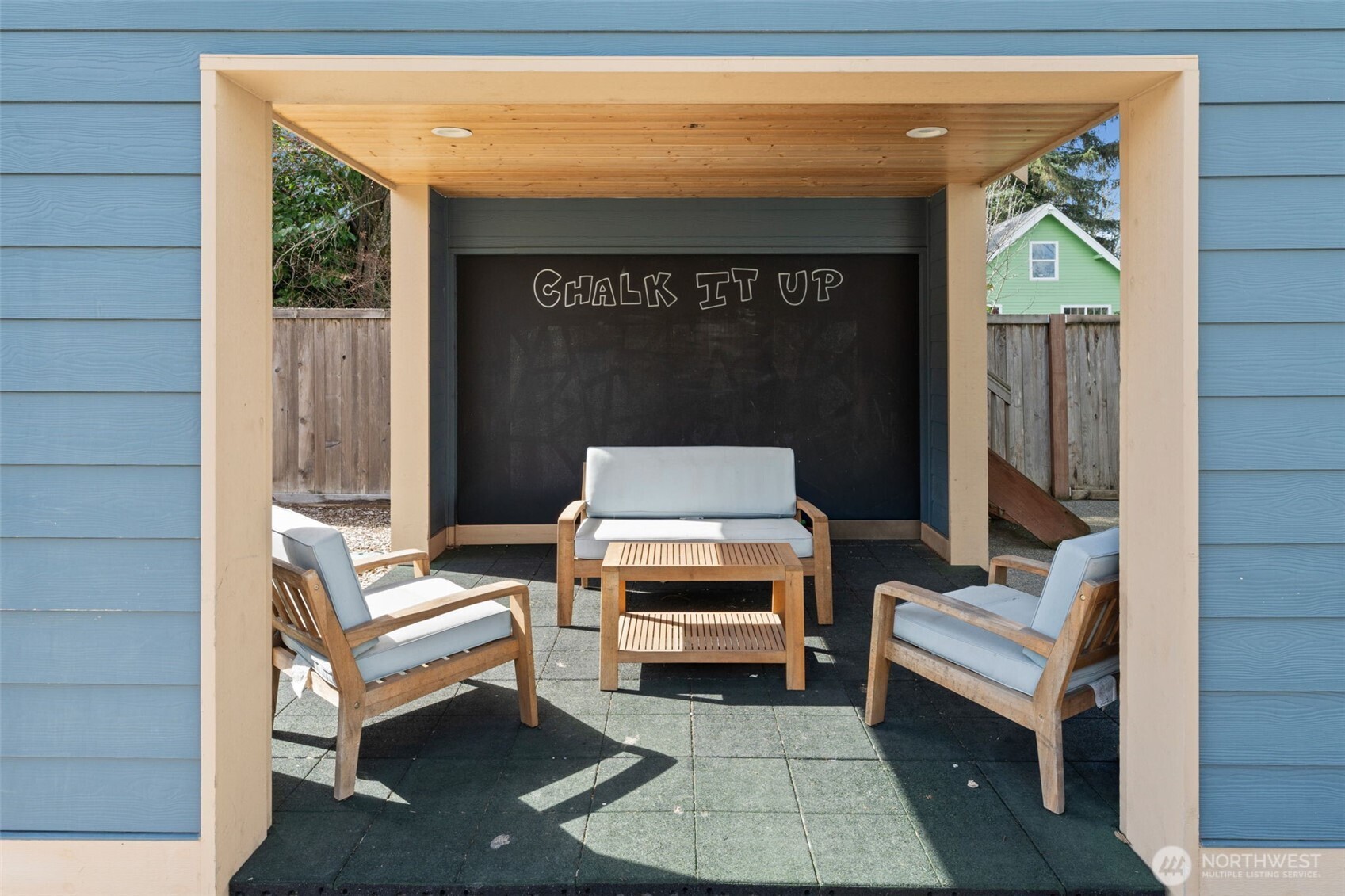 Covered section of the detached outdoor structure, adding charm and flexible exterior use.